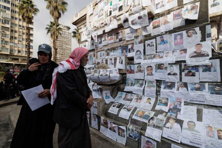 Hamed Khalef Ali, who said his son is missing, looks at pictures of missing people, believed to be prisoners from Sednaya prison, which was known as a slaughterhouse under the rule of Syria's Bashar al-Assad who has been ousted, in Marjeh Square, also known as Martyrs' Square, in Damascus, Syria, December 22, 2024. REUTERS/Zohra Bensemra