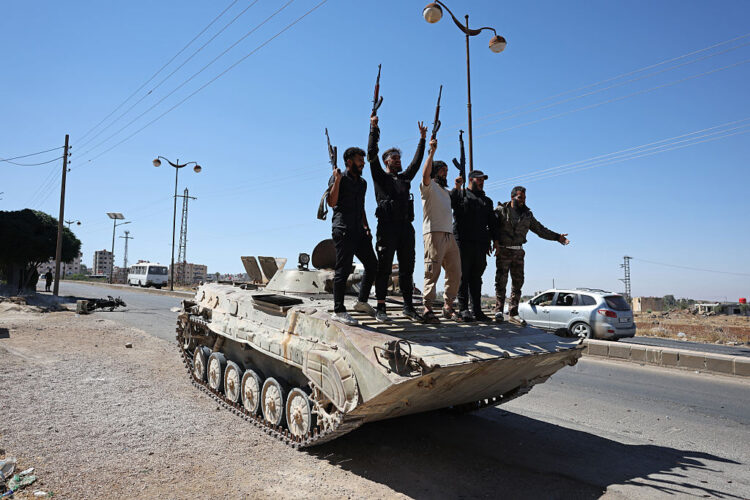 SWEIDA, SYRIA - JULY 15: Syrian security forces stand atop a tank on July 15, 2025 near Sweida, Syria. The Syrian Ministry of Defence announced Monday that it has begun deploying military units to the southern province of Sweida (also spelled Suwayda or Suweida), following sectarian clashes between Druze fighters and Bedouin tribes that left at least 37 people dead and 100 injured as of July 14. The violence erupted after several kidnappings on both sides, including the abduction of a Druze merchant on Friday. (Photo by Stringer/Getty Images)